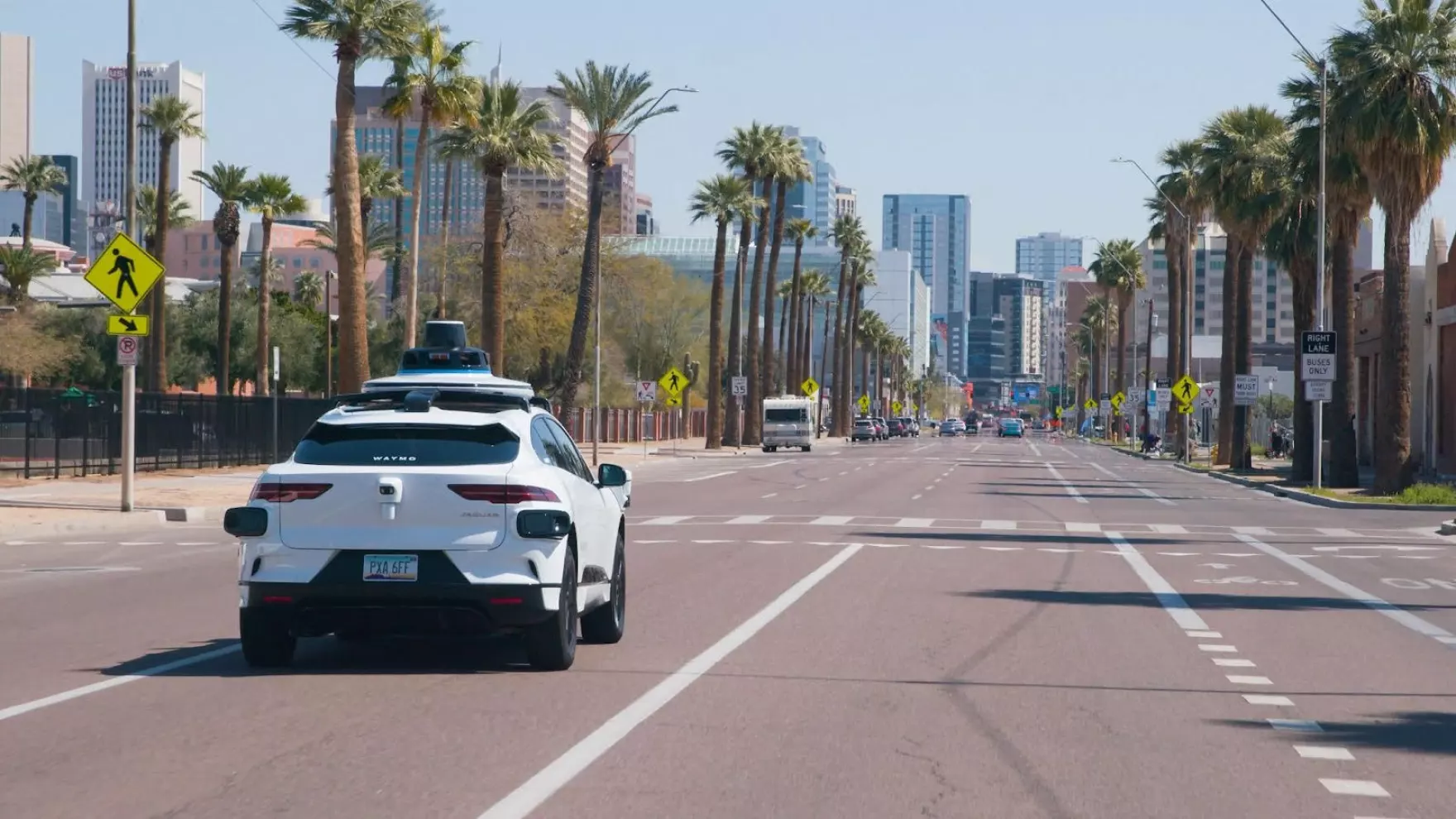 A Waymo autonomous vehicle driving on a road in Phoenix, Arizona